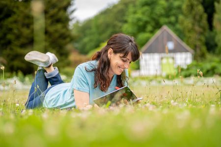 Vrouw liggend op het gazon in de botanische tuin van Bielefeld