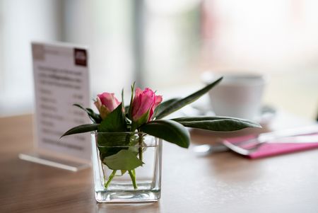 Twee roze rozen als tafeldecoratie in Hotel im Park